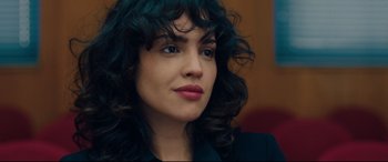 Movie still from “I Care a Lot” (2020), directed by J Blakeson – A person with curly hair; Close Up shot, Over the shoulder angle