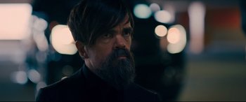 Movie still from “I Care a Lot” (2020), directed by J Blakeson – A person with a beard; Close Up shot, Over the shoulder angle