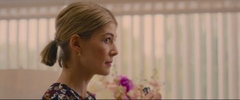 Movie still from “I Care a Lot” (2020), directed by J Blakeson – A person holding a cell phone; Close Up shot, Over the shoulder angle