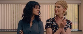 Movie still from “I Care a Lot” (2020), directed by J Blakeson – Two women standing next to each other in front of a window; Close Up shot, Low angle