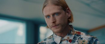 Movie still from “I Care a Lot” (2020), directed by J Blakeson – A person with long blonde hair; Close Up shot, Over the shoulder angle