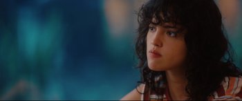 Movie still from “I Care a Lot” (2020), directed by J Blakeson – A person with curly black hair; Close Up shot, Over the shoulder angle
