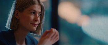 Movie still from “I Care a Lot” (2020), directed by J Blakeson – A person sitting in front of a window; Close Up shot, Over the shoulder angle