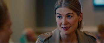 Movie still from “I Care a Lot” (2020), directed by J Blakeson – A person wearing a jacket; Close Up shot, Over the shoulder angle