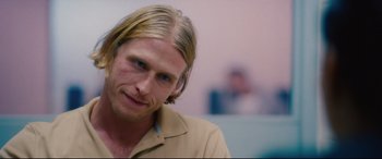 Movie still from “I Care a Lot” (2020), directed by J Blakeson – A person with long blonde hair; Close Up shot, Over the shoulder angle