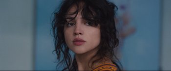 Movie still from “I Care a Lot” (2020), directed by J Blakeson – A person wearing a yellow and orange shirt; Close Up shot, Low angle