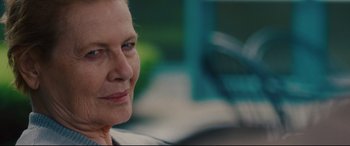 Movie still from “I Care a Lot” (2020), directed by J Blakeson – An older woman is sitting in front of a blue chair; Close Up shot, Over the shoulder angle