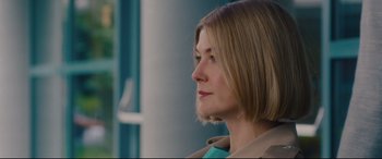 Movie still from “I Care a Lot” (2020), directed by J Blakeson – A person wearing a jacket; Close Up shot, Over the shoulder angle