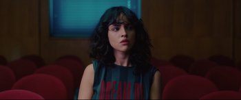 Movie still from “I Care a Lot” (2020), directed by J Blakeson – A woman sitting in a chair looking at the camera; Close Up shot, Low angle