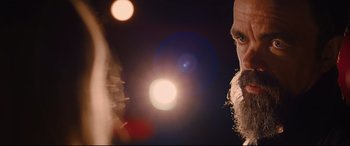 Movie still from “I Care a Lot” (2020), directed by J Blakeson – A man with a long beard is looking into a mirror; Close Up shot, Low angle