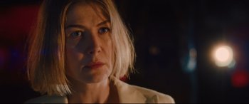 Movie still from “I Care a Lot” (2020), directed by J Blakeson – A person wearing a white shirt; Close Up shot, Over the shoulder angle