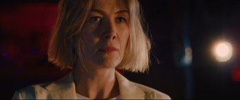 Movie still from “I Care a Lot” (2020), directed by J Blakeson – A person wearing a white shirt; Close Up shot, Low angle