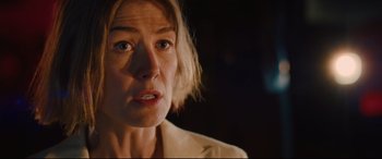 Movie still from “I Care a Lot” (2020), directed by J Blakeson – A person with short blonde hair; Close Up shot, Over the shoulder angle