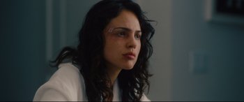 Movie still from “I Care a Lot” (2020), directed by J Blakeson – A young woman is looking into the distance; Close Up shot, Low angle