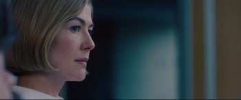 Movie still from “I Care a Lot” (2020), directed by J Blakeson – A woman's face in a dark room; Close Up shot, Over the shoulder angle