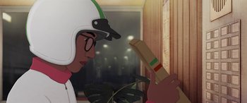 Movie still from “I Lost My Body” (2019), directed by Jérémy Clapin – A person wearing a helmet and holding a book; Close Up shot, Over the shoulder angle