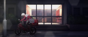 Movie still from “I Lost My Body” (2019), directed by Jérémy Clapin – A person riding a bike in a room with a window; Extreme Wide shot, Low angle