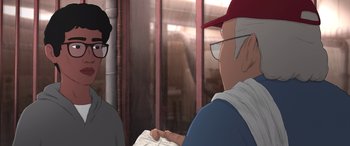 Movie still from “I Lost My Body” (2019), directed by Jérémy Clapin – A man wearing glasses and a red hat is reading a newspaper; Medium shot, Over the shoulder angle