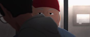 Movie still from “I Lost My Body” (2019), directed by Jérémy Clapin – An older man wearing a red hat looking into the camera; Extreme Close Up shot, Over the shoulder angle