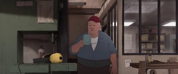 Movie still from “I Lost My Body” (2019), directed by Jérémy Clapin – An animated man holding a cup in his hand; Medium shot, Low angle