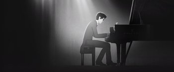 Movie still from “I Lost My Body” (2019), directed by Jérémy Clapin – A black and white illustration of a man sitting at a piano; Medium shot, Low angle