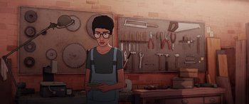 Movie still from “I Lost My Body” (2019), directed by Jérémy Clapin – A man standing in front of a work bench holding a cell phone; Medium shot, High angle