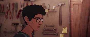 Movie still from “I Lost My Body” (2019), directed by Jérémy Clapin – An illustration of a man in glasses looking at a wall of tools; Close Up shot, High angle