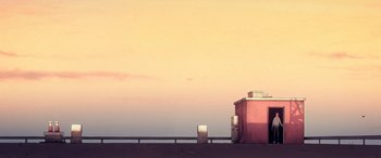 Movie still from “I Lost My Body” (2019), directed by Jérémy Clapin – A pink building with a sky in the background; Extreme Wide shot, Low angle