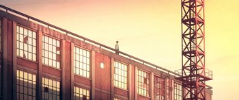 Movie still from “I Lost My Body” (2019), directed by Jérémy Clapin – A man standing on the edge of a building; Extreme Wide shot, Low angle