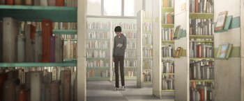 Movie still from “I Lost My Body” (2019), directed by Jérémy Clapin – A man standing in a library holding a book; Wide shot, Low angle