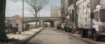 Movie still from “I Lost My Body” (2019), directed by Jérémy Clapin – An illustration of an overpass with cars parked on the side of the road; Extreme Wide shot, High angle