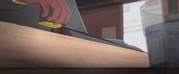 Movie still from “I Lost My Body” (2019), directed by Jérémy Clapin – A person using a pair of scissors to cut a piece of wood; Extreme Close Up shot, High angle