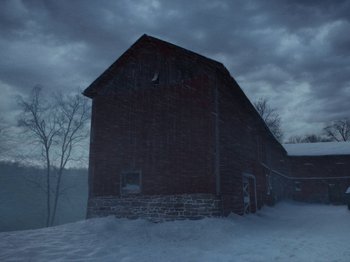 Movie still from “I'm Thinking of Ending Things” (2020), directed by Charlie Kaufman – A barn in the middle of a snowy field at night; Extreme Wide shot, Low angle