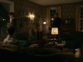 Movie still from “I'm Thinking of Ending Things” (2020), directed by Charlie Kaufman – A group of people sitting around a living room; Wide shot, High angle