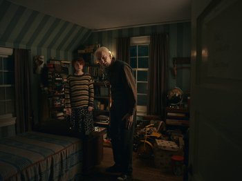 Movie still from “I'm Thinking of Ending Things” (2020), directed by Charlie Kaufman – A man and a woman standing in a bedroom; Wide shot, High angle