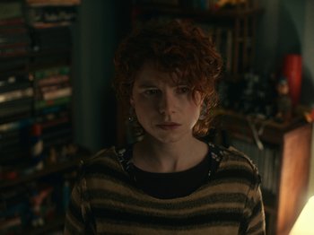 Movie still from “I'm Thinking of Ending Things” (2020), directed by Charlie Kaufman – A woman with curly red hair wearing a striped sweater; Close Up shot, Over the shoulder angle