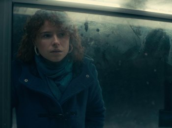 Movie still from “I'm Thinking of Ending Things” (2020), directed by Charlie Kaufman – A woman standing in front of a car window; Close Up shot, Over the shoulder angle