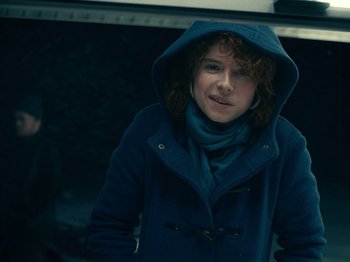 Movie still from “I'm Thinking of Ending Things” (2020), directed by Charlie Kaufman – A woman wearing a blue coat and a blue scarf; Close Up shot, Low angle