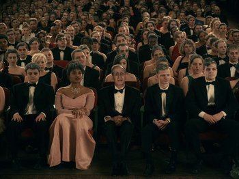 Movie still from “I'm Thinking of Ending Things” (2020), directed by Charlie Kaufman – A group of people sitting in rows in a theater; Wide shot, High angle