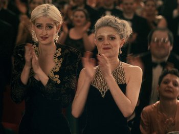 Movie still from “I'm Thinking of Ending Things” (2020), directed by Charlie Kaufman – Two women clapping in front of an audience; Medium shot, Low angle