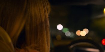 A blurry image of a woman's face at night