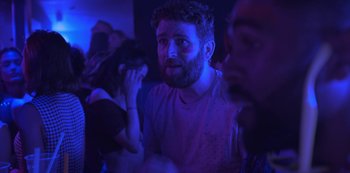 A man with a goatee is looking at the camera