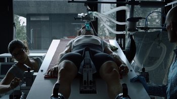 Movie still from “Icarus” (2017), directed by Bryan Fogel – A man is laying down on a machine; Medium shot, Low angle