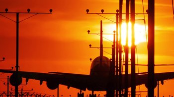 Movie still from “Icarus” (2017), directed by Bryan Fogel – An airplane on the tarmac at sunset; Extreme Wide shot, Low angle