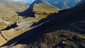 Movie still from “Icarus” (2017), directed by Bryan Fogel – A view of a mountain valley from a hill side; Extreme Wide shot, High angle