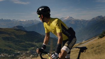 Movie still from “Icarus” (2017), directed by Bryan Fogel – A man riding a bike on top of a mountain; Extreme Wide shot, Low angle