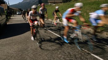 Movie still from “Icarus” (2017), directed by Bryan Fogel – A group of men riding bikes down a street; Extreme Wide shot, High angle