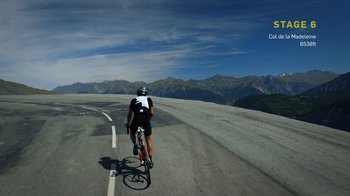 Movie still from “Icarus” (2017), directed by Bryan Fogel – A man riding a bike down the side of a road; Extreme Wide shot, High angle