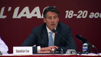 Movie still from “Icarus” (2017), directed by Bryan Fogel – A man sitting at a table in front of microphones; Medium shot, Low angle