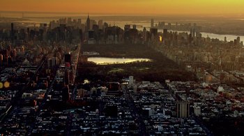 Movie still from “Icarus” (2017), directed by Bryan Fogel – An aerial view of a large city at sunset; Extreme Wide shot, High angle